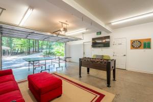 a living room with a ping pong table and a ping pong table at Dragonfly Cove - Private Dock in Mooresville