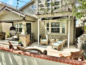 a patio with chairs and a table and a building at Park Avenue Beach Paradise - Chic & Secluded 4 BDR in Long Beach
