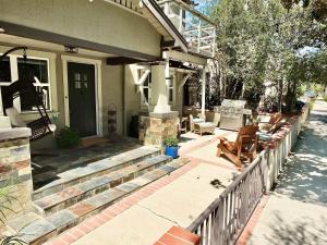 a porch of a house with a fence at Park Avenue Beach Paradise - Chic & Secluded 4 BDR in Long Beach +33 photos
