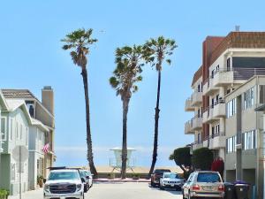a group of palm trees on a street next to a building at Beach & Bay Retreat - Full of Amenities in Long Beach