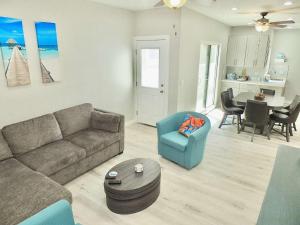 a living room with a couch and chairs and a table at Beach & Bay Retreat - Full of Amenities in Long Beach +21 photos