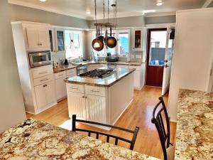 a kitchen with white cabinets and a counter top at Beach City Craftsman - Walk to Beach in Long Beach