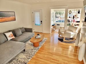 a living room with a couch and a table at Beach City Craftsman - Walk to Beach in Long Beach