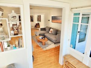 a living room with a couch and a table at Beach City Craftsman - Walk to Beach in Long Beach