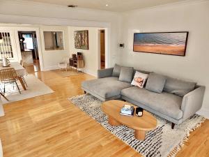 a living room with a couch and a table at Beach City Craftsman - Walk to Beach in Long Beach +39 photos