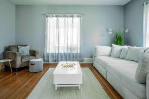 a living room with a couch and a table at Maplewood Manor - Chic 6 BDR Downtown Walworth in Walworth