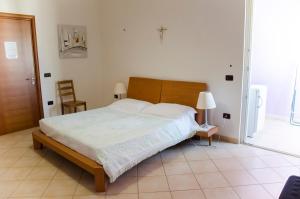 a bedroom with a large bed with a wooden headboard at B&B Ore Liete in Martano