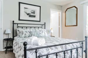 a bedroom with a bed with a black and white comforter at Vida del Lago - 3 Bedroom Near Geneva National in Lake Geneva