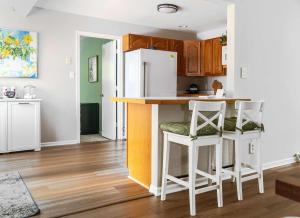a kitchen with a counter and two stools at Vida del Lago - 3 Bedroom Near Geneva National in Lake Geneva