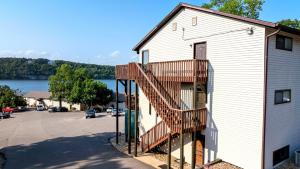 a building with a staircase next to a parking lot at The Nook at Weston Point - Cozy Condo Getaway in Osage Beach