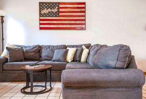 a couch in a living room with an american flag on the wall at Briarwood Serenity at Abbey Springs - Quiet 4 BDR in Lake Geneva