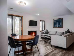 a living room with a table and a couch at Briarwood Serenity at Abbey Springs - Quiet 4 BDR in Lake Geneva