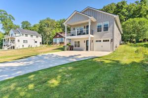 a large house with a driveway in front of it at Como Collection - 2 Homes 2 Lakes 1 Rental in Lake Geneva