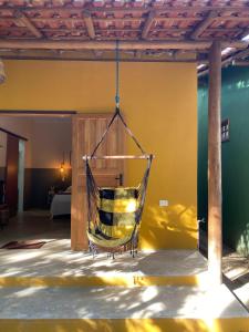 a hammock is hanging from a porch at Chalés Borborema Cumuru in Prado