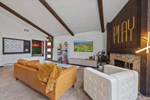 a living room with two couches and a fireplace at Game Lovers Getaway In Abbey Springs with Golf Cart in Lake Geneva