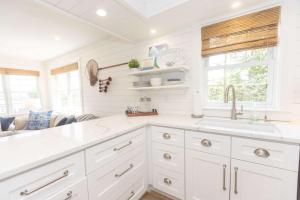 a kitchen with white cabinets and a sink at Heaven on Earth 2 BDR Fontana Flat Walk to Lake in Lake Geneva
