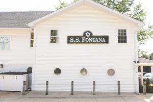 a white building with a street sign on it at Heaven on Earth 2 BDR Fontana Flat Walk to Lake in Lake Geneva