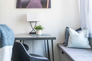 a room with a desk with a chair and a lamp at The Hideaway at Hayloft Lodge - Chic & Unique Stay in Lake Geneva