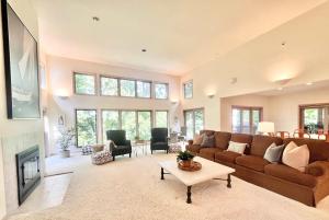 a living room with a couch and a fireplace at Spacious 4 BDR Home in Desirable Abbey Springs in Lake Geneva