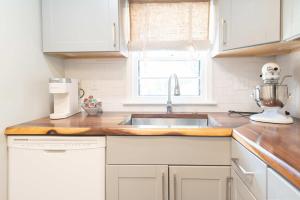 a kitchen counter with a mixer and a sink at Chic Downtown Lake Geneva Apartment - Sleeps 2 in Lake Geneva
