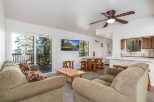 a living room with two couches and a ceiling fan at Yosemite Quail - Nestled in with a View in Yosemite West