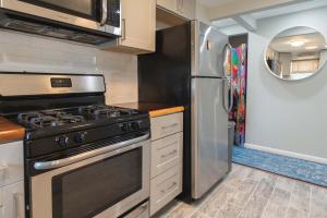 a kitchen with a stove and a refrigerator at Chic Downtown Lake Geneva Apartment - Sleeps 2 in Lake Geneva +9 photos