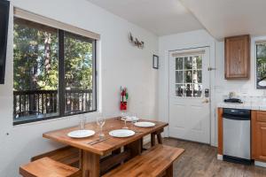 a kitchen with a wooden table and a window at Yosemite Quail - Nestled in with a View in Yosemite West