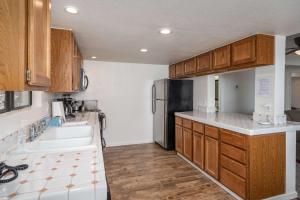 a kitchen with a sink and a refrigerator at Yosemite Quail - Nestled in with a View in Yosemite West