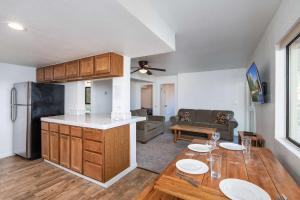 a kitchen and living room with a table and a refrigerator at Yosemite Quail - Nestled in with a View in Yosemite West