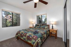 a bedroom with a bed and two windows at Yosemite Quail - Nestled in with a View in Yosemite West