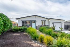 a white house with a lot of grass at Your Dream Seaside Vacation Charming 2 BDR Home in Seaside