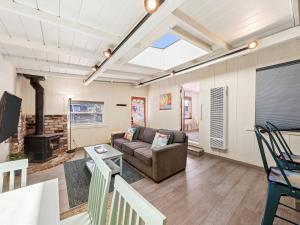 a living room with a couch and a fireplace at Cottage at the Point - For 4 in Santa Cruz