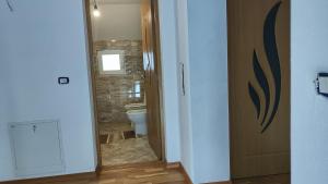 a bathroom with a toilet and a glass door at Vila Ciciou in Negreşti-Oaş +29 photos