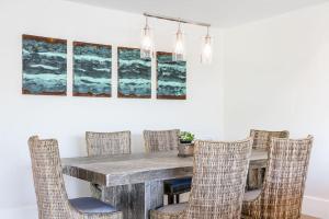a dining room with a wooden table and chairs at A True Vacation Masterpiece in Corona del Mar