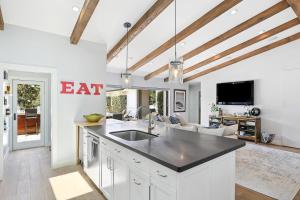 a kitchen with a sink and a living room at Private Wading Pool Home with Patio in Corona del Mar