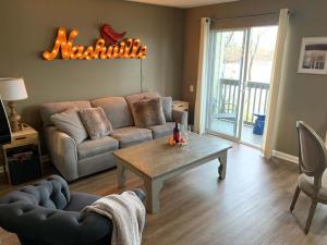 a living room with a couch and a coffee table at Riverfront Condo in DT in Nashville
