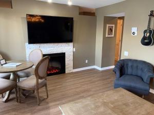 a living room with a table and a fireplace at Riverfront Condo in DT in Nashville
