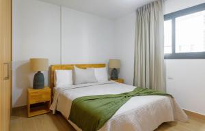 a bedroom with a bed and two lamps and a window at Sausalito | Pool View Retreat in Punta Cana +18 photos