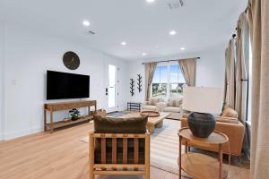 a living room filled with furniture and a flat screen tv at Chic Modern Farm Haus - Minutes to Everything in New Braunfels +29 photos