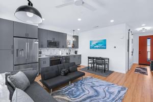 a living room with a couch and a kitchen at Pacific Island Inspired Stay - Amazing Location in New Braunfels +30 photos
