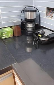 a kitchen counter top with a coffee maker on it at Studio Luiz Leopoldo in Niterói +5 photos