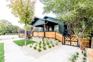 a home with a black house with a flag at Best Location in Downtown NB - Golf Cart Included in New Braunfels