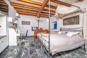 a bedroom with a bed and a desk at Villa Archontissa in Spetses
