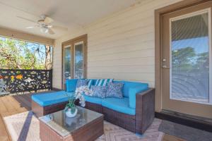 a porch with a blue couch and a glass table at Spacious Retreat & Game Room - Sleeps 8 in New Braunfels