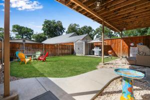 a patio with a table and chairs in a yard at Spacious Retreat & Game Room - Sleeps 8 in New Braunfels