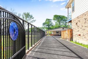 a iron fence with a blue frisbee on it at Beautiful and Relaxing Lakefront Getaway in New Braunfels +37 photos