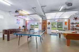 a room with two ping pong tables in it at Amazing Lakefront Escape - A Stunner For Sleeps 14 in New Braunfels