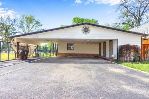 a large white garage with a driveway at Amazing Lakefront Escape - A Stunner For Sleeps 14 in New Braunfels