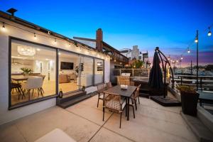Un patio con una mesa y sillas en un balcón. en Bayside Getaway Waterfront, en Newport Beach