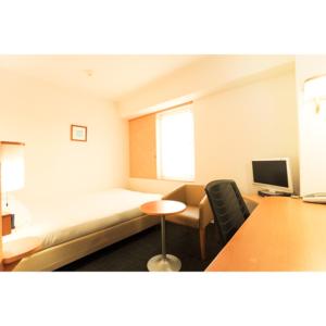 a room with a bed and a desk and a computer at Smile Hotel Shiogama - Vacation STAY 84726v in Shiogama